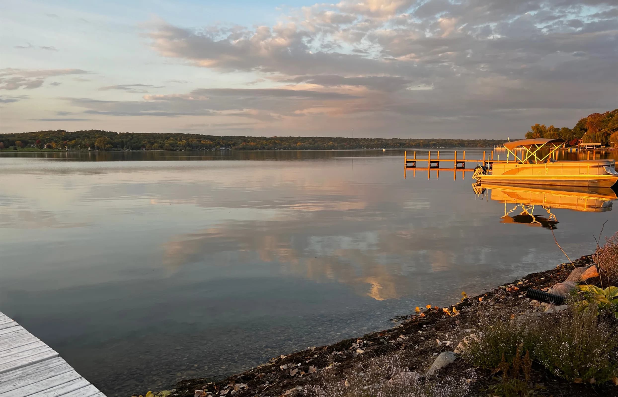 Still water and a pier at sunrise