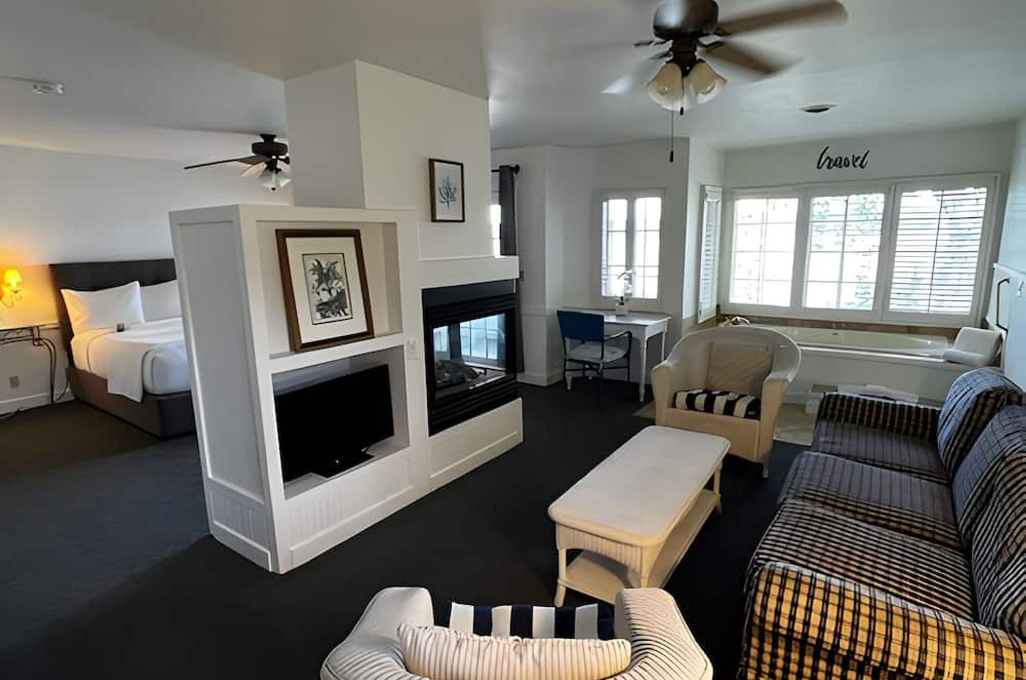 The Cottage Suite, with the bed and the sitting area on either side of a double-sided fireplace